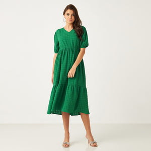 Max emerald green textured tiered dress front view on model with silver heels