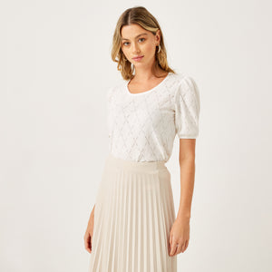 Max white pointelle knit top back view on model showing puff sleeve and diamond texture